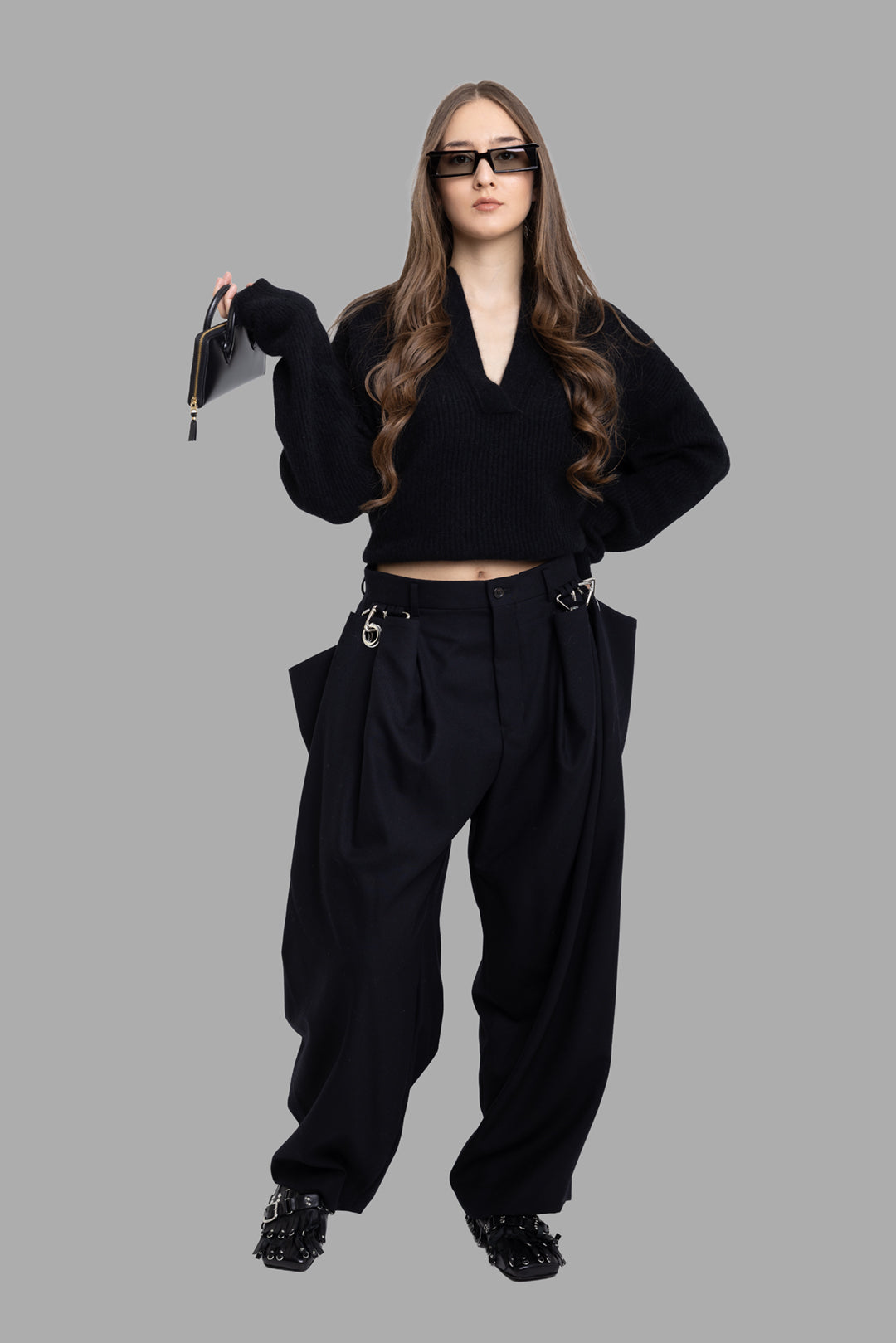 Noir Kei Ninomiya women’s black wool trousers, full-length front on model with wide legs and exaggerated side panels