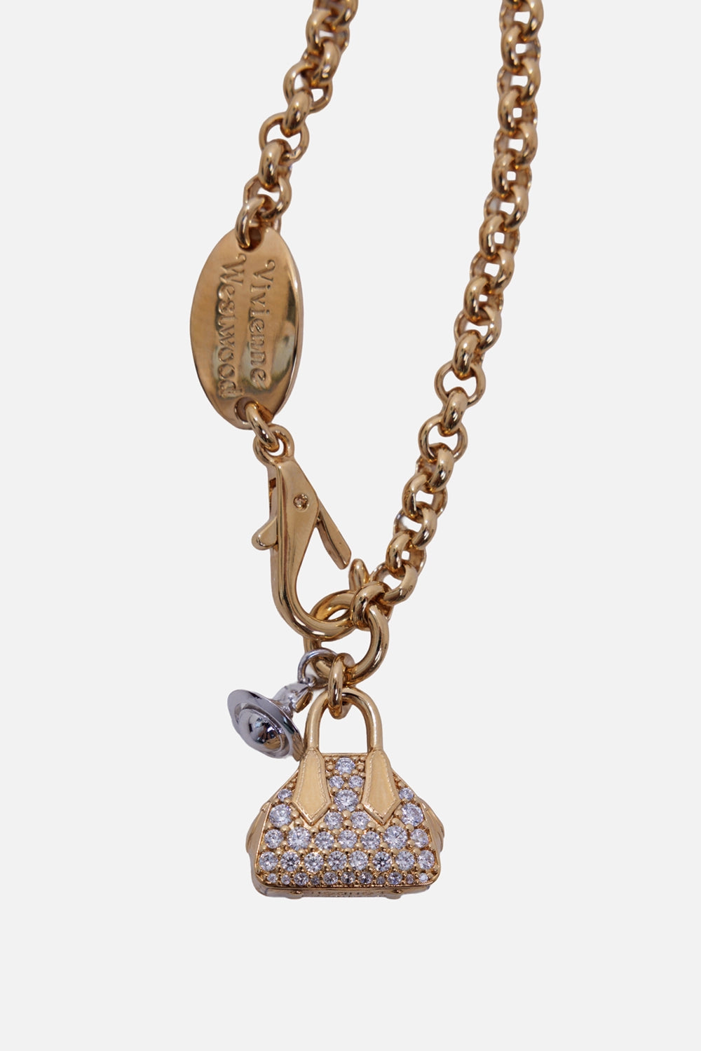 Vivienne Westwood women's Yasmine bracelet in platinum and gold, close-up with pavé bag charm and engraved logo tag